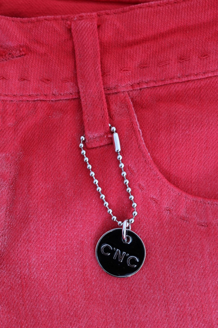 Red cotton stretch slim jeans with a silver bead chain charm hanging from the belt loop