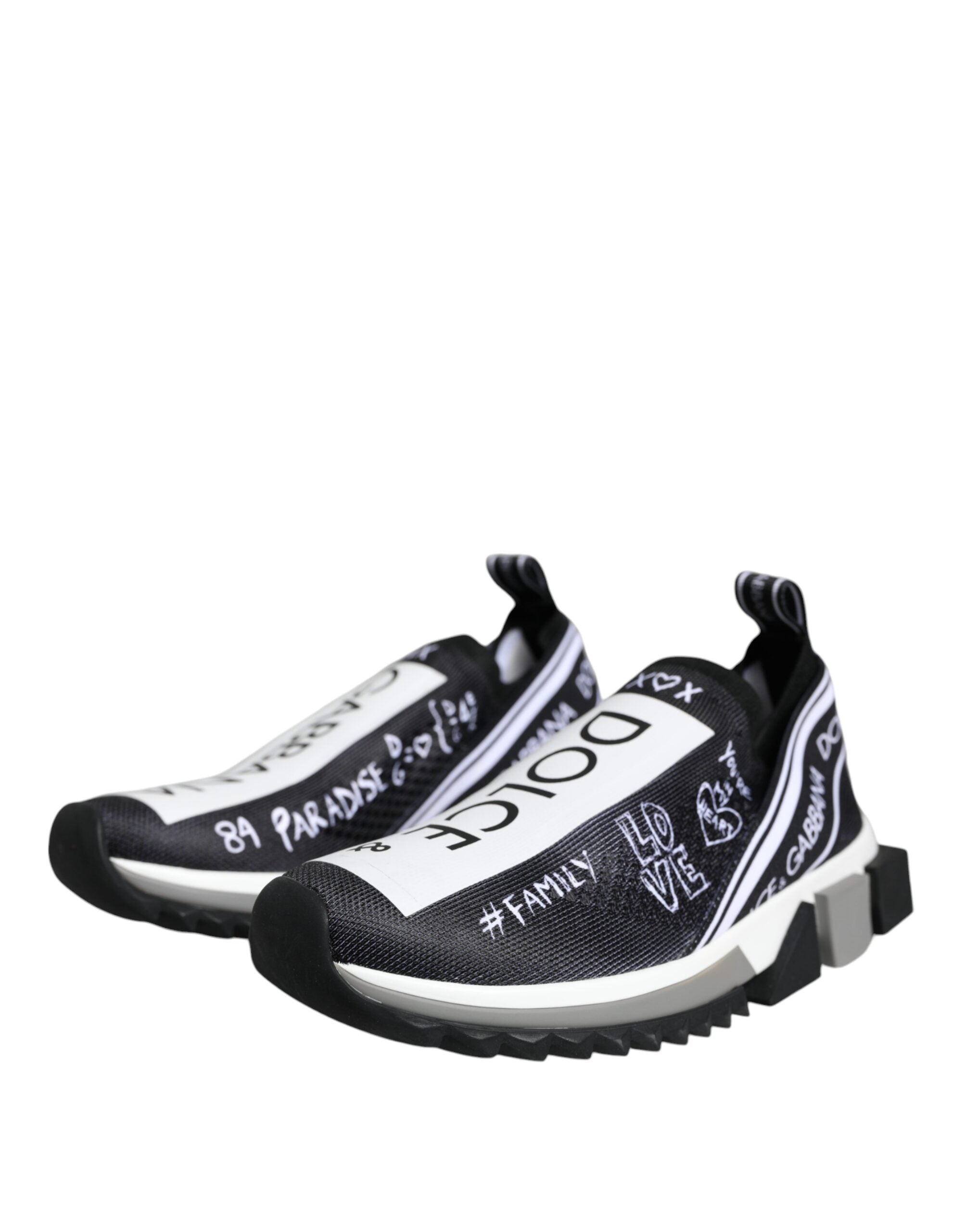 Dolce & Gabbana black and white Sorrento mesh slip-on sneakers with white graffiti-style logo text and thick soles.