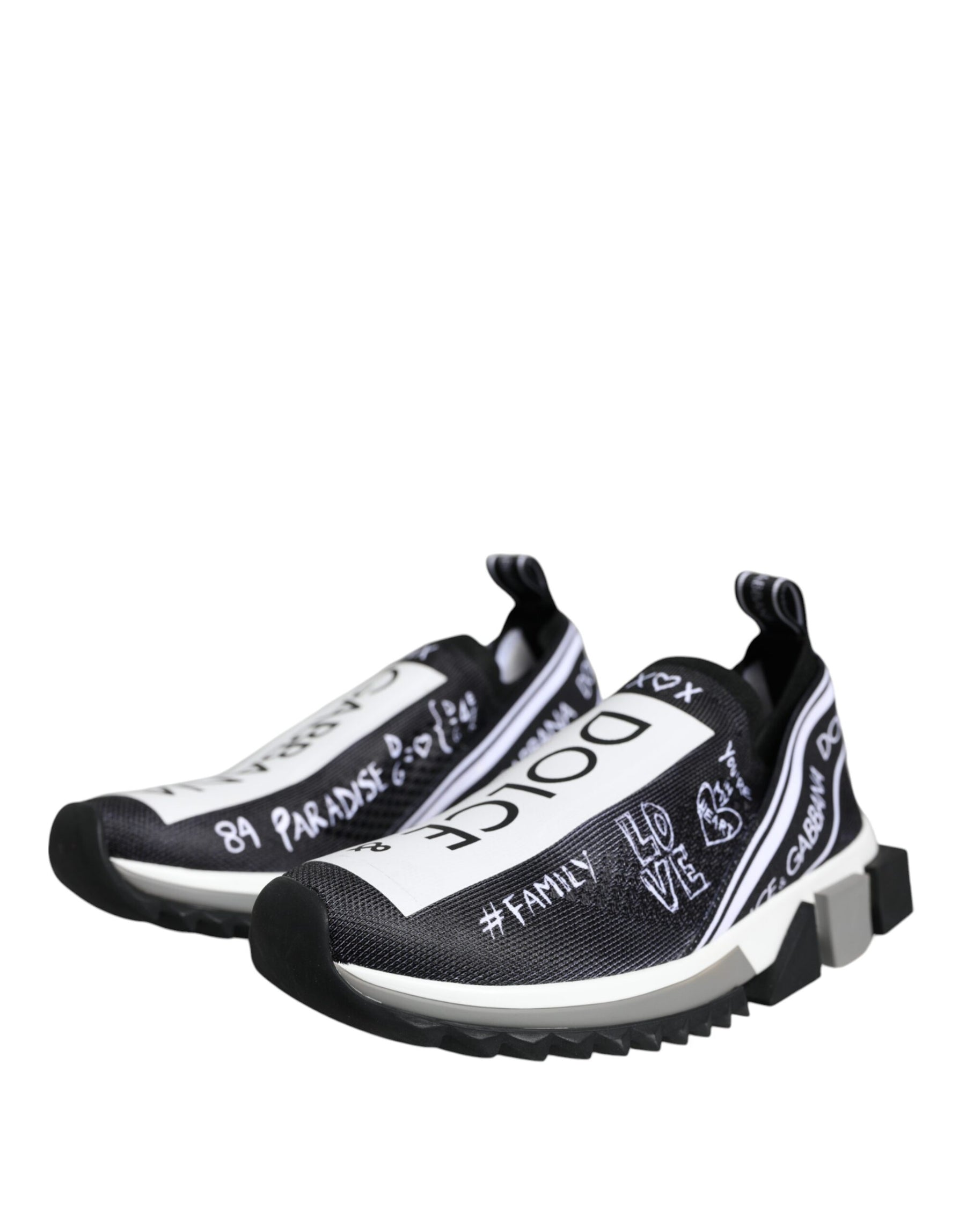 Dolce & Gabbana black and white Sorrento mesh slip-on sneakers with white graffiti-style logo text and thick soles.
