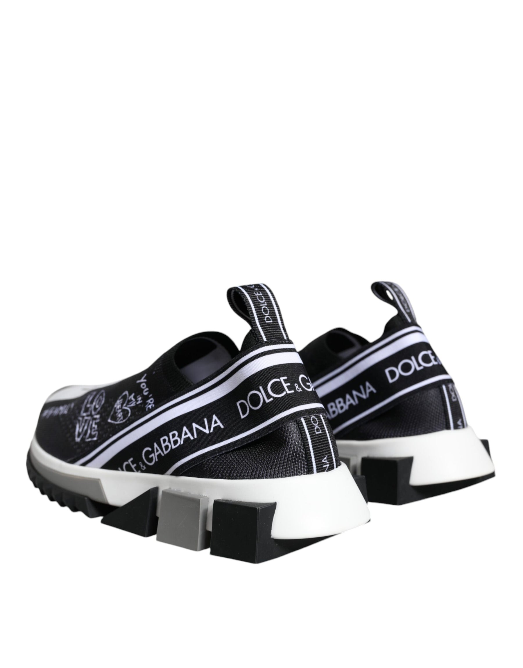 Dolce & Gabbana black and white slip-on sneakers in stretch knit with logo branding and geometric rubber soles.