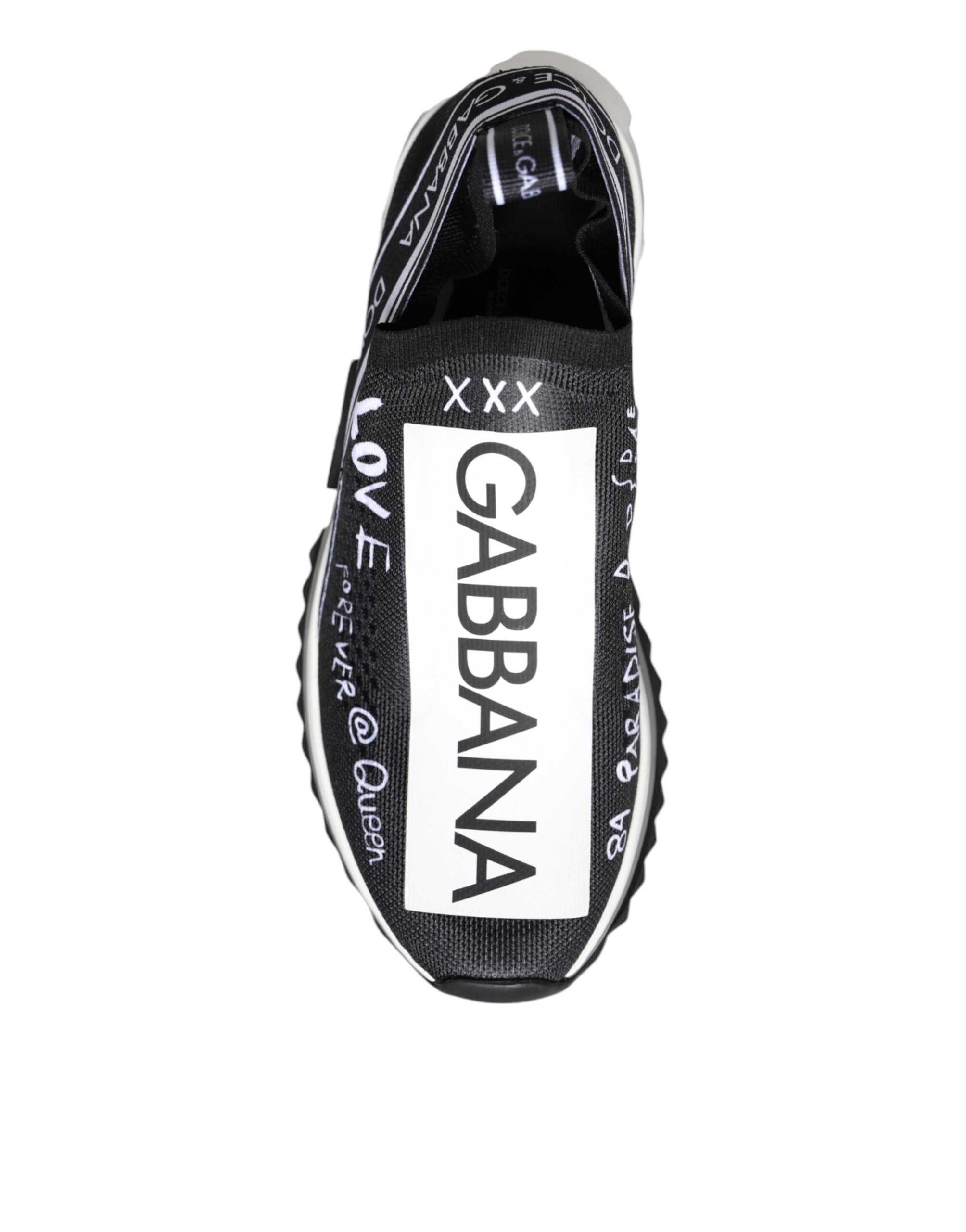 Dolce & Gabbana black and white slip-on sneaker in mesh fabric with white graffiti-style logo and text graphics.