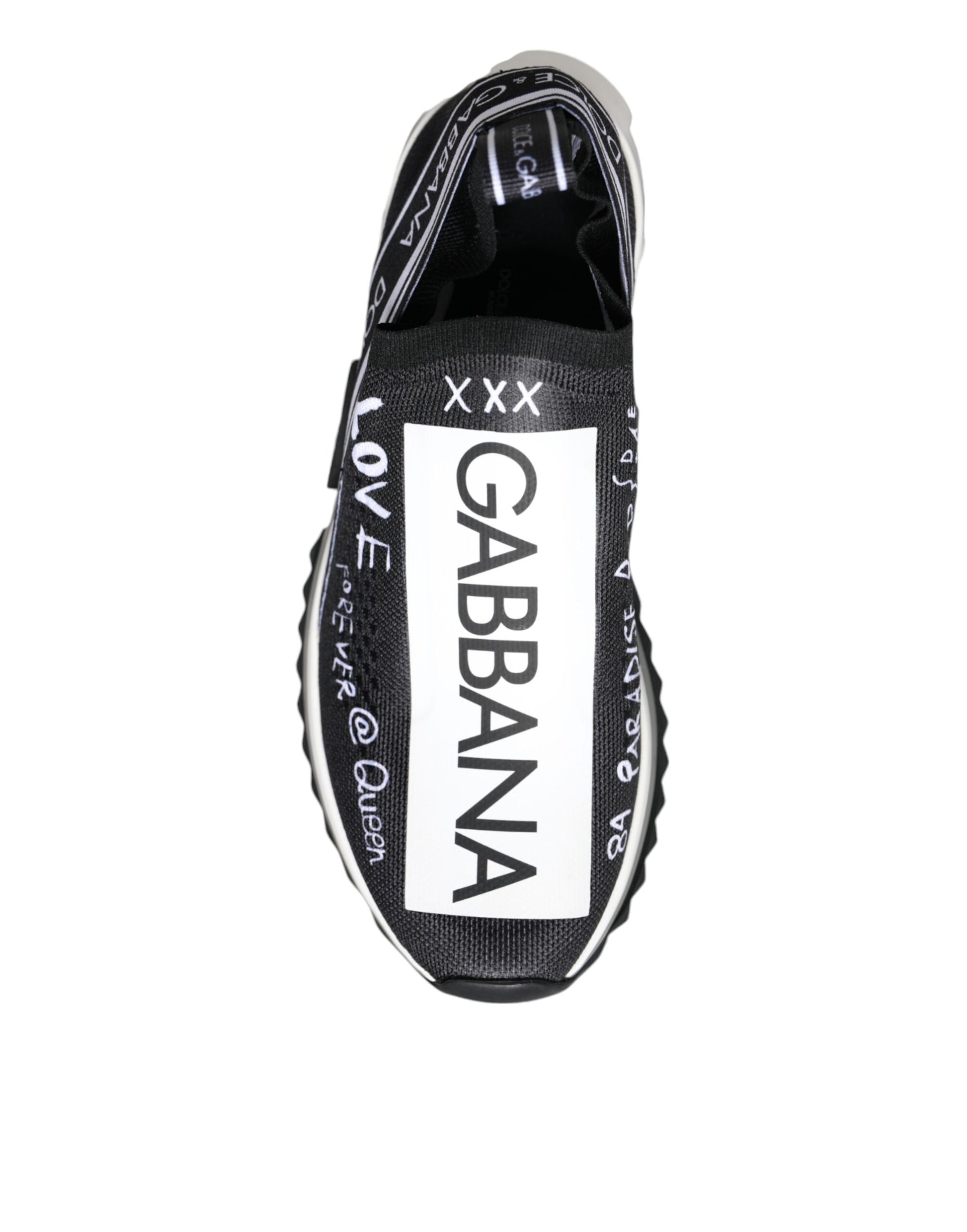 Dolce & Gabbana black and white slip-on sneaker in mesh fabric with white graffiti-style logo and text graphics.