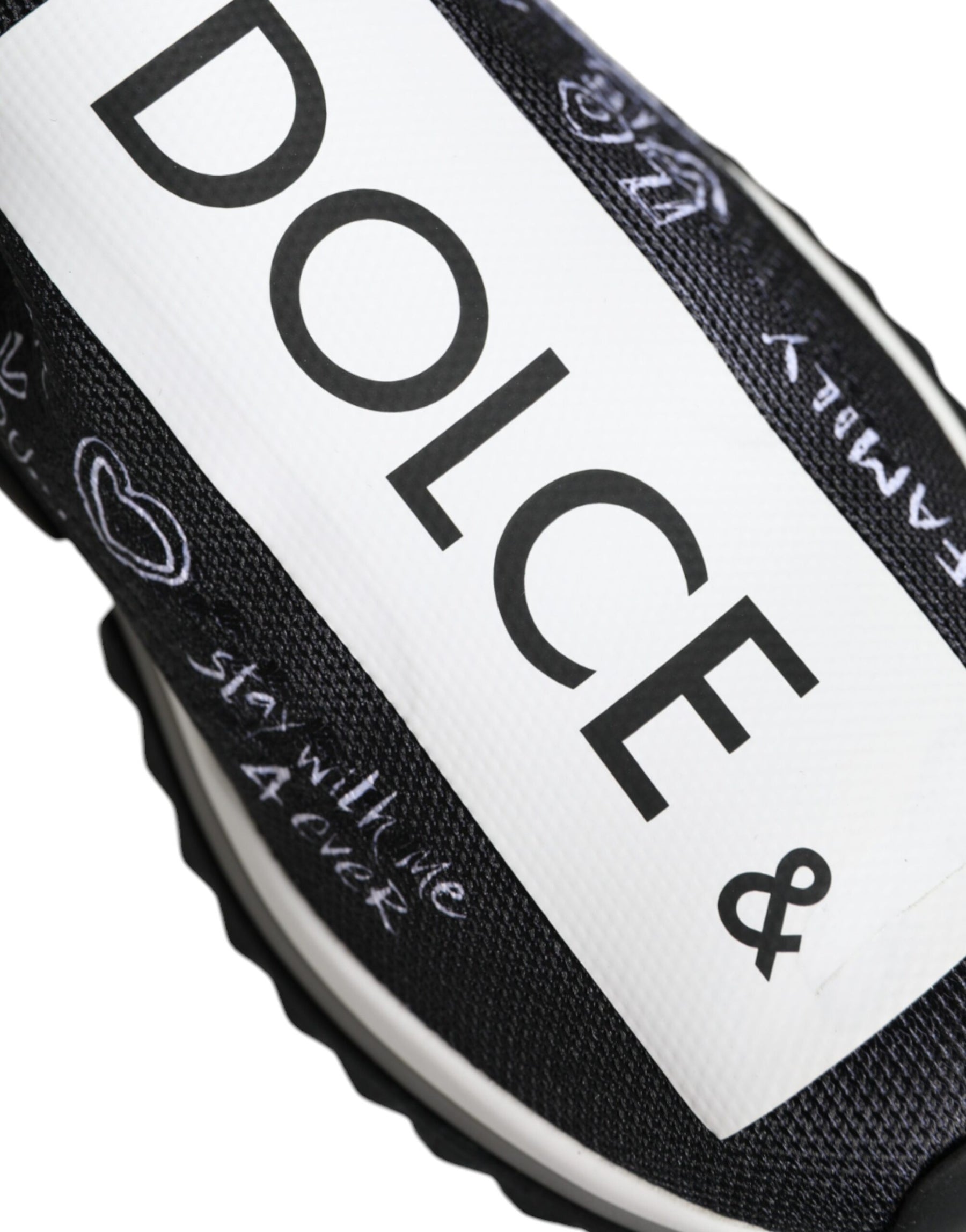 Black and white stretch knit Dolce & Gabbana Sorrento slip-on sneaker with graffiti-style text and heart graphics.