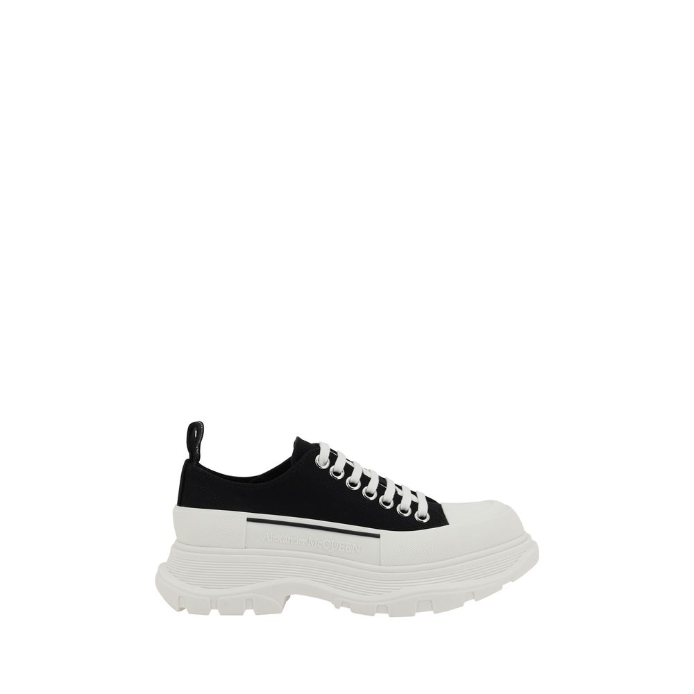 Alexander McQueen black cotton chunky low-top sneaker with a thick white lugged rubber sole and white laces.