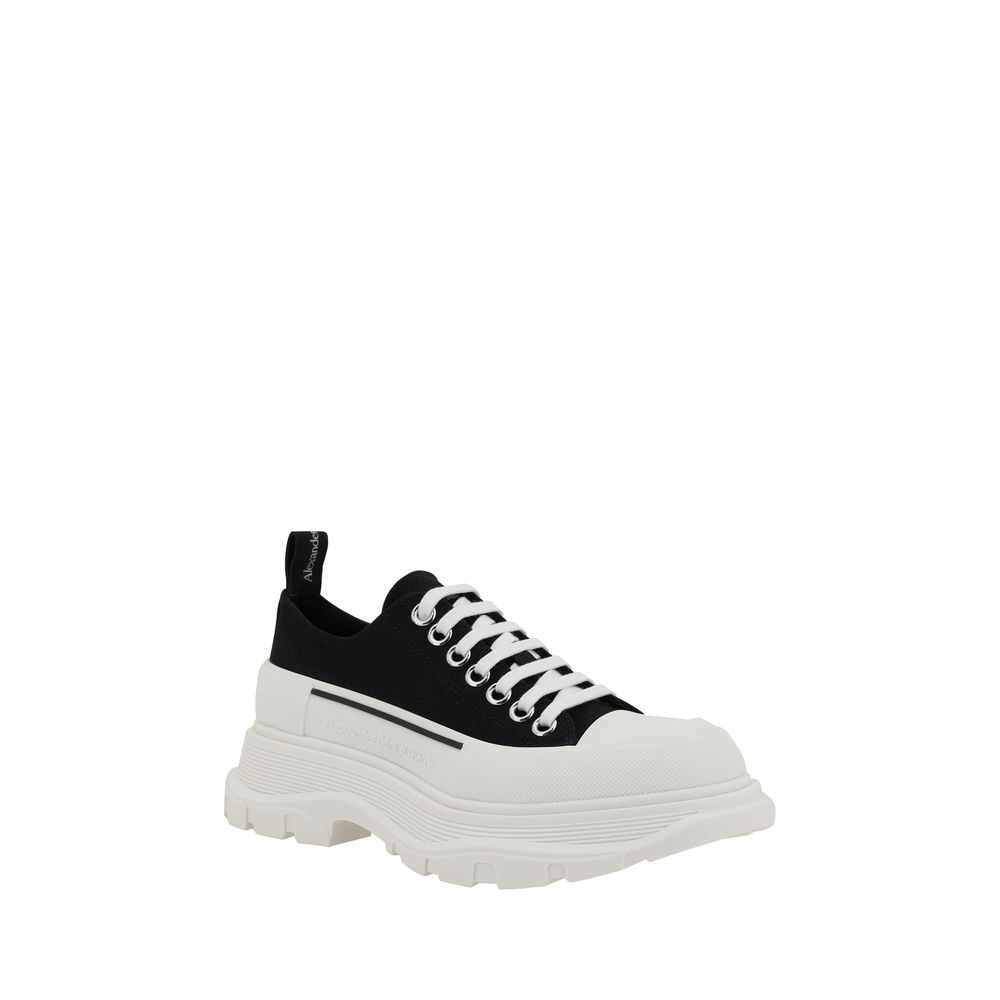 Alexander McQueen black cotton chunky sneakers with white laces and a thick, textured white rubber lug sole.