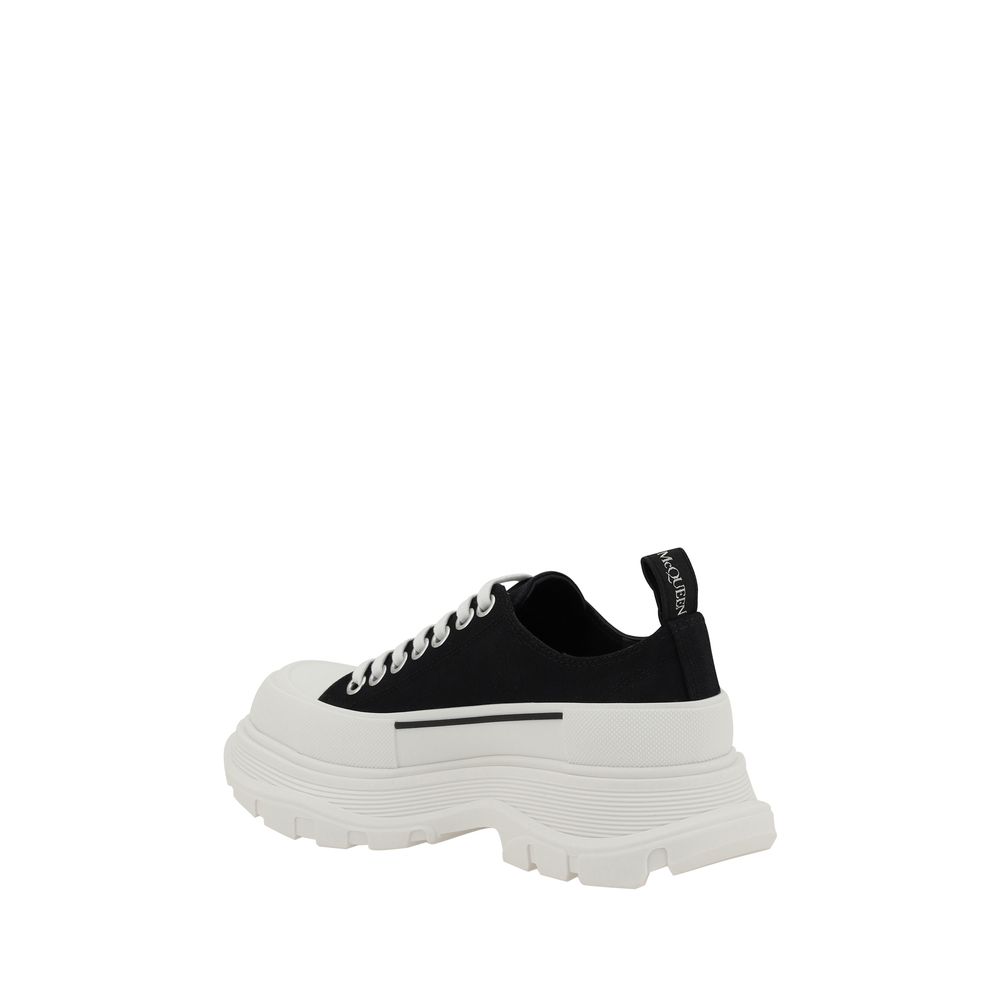 Alexander McQueen black cotton chunky sneaker with white laces and a thick, ridged white platform rubber sole.