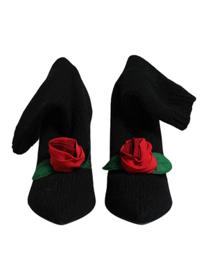 Dolce & Gabbana black ribbed knit mid-calf stiletto boots featuring a prominent red fabric rose with green leaves.