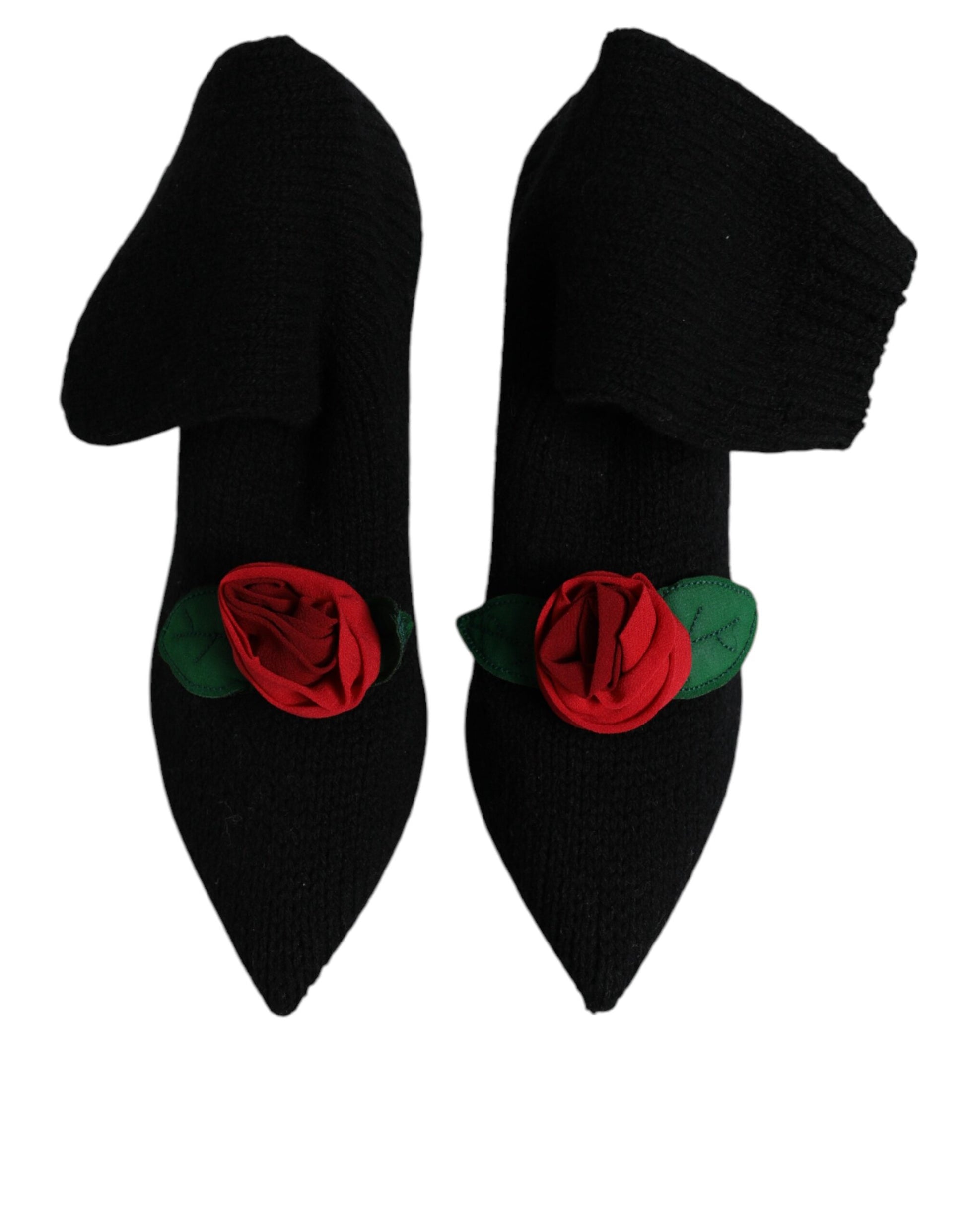 Black knit mid-calf stiletto boots featuring a red fabric rose appliqué with green leaves on the pointed toes.