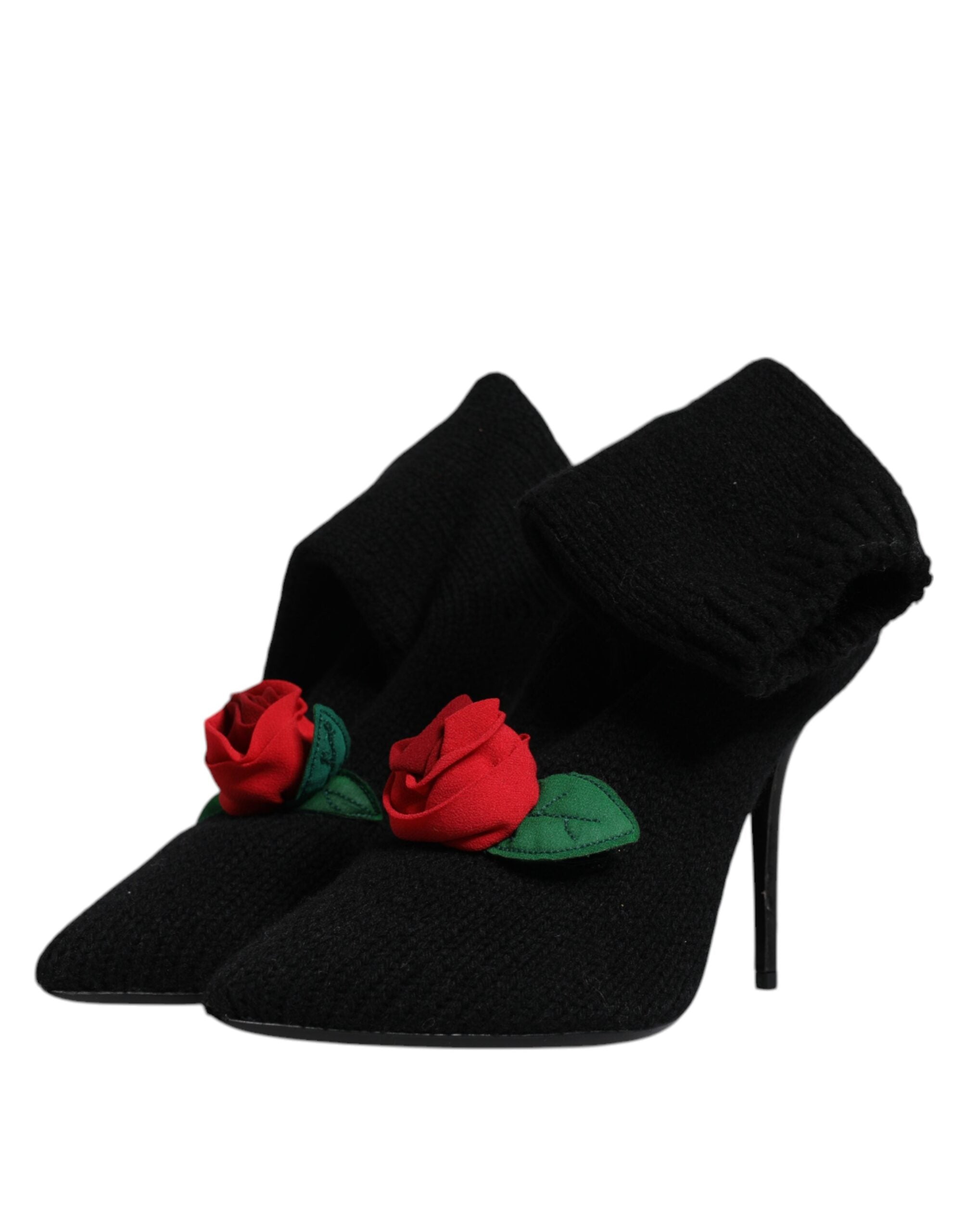 Black Dolce & Gabbana knit mid-calf stiletto boots featuring pointed toes and decorative red rose accents with leaves.