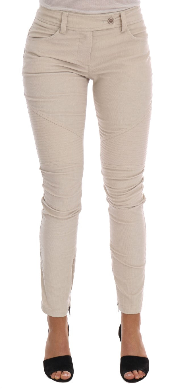 Beige corduroy skinny pants with a slim fit and moto detailing