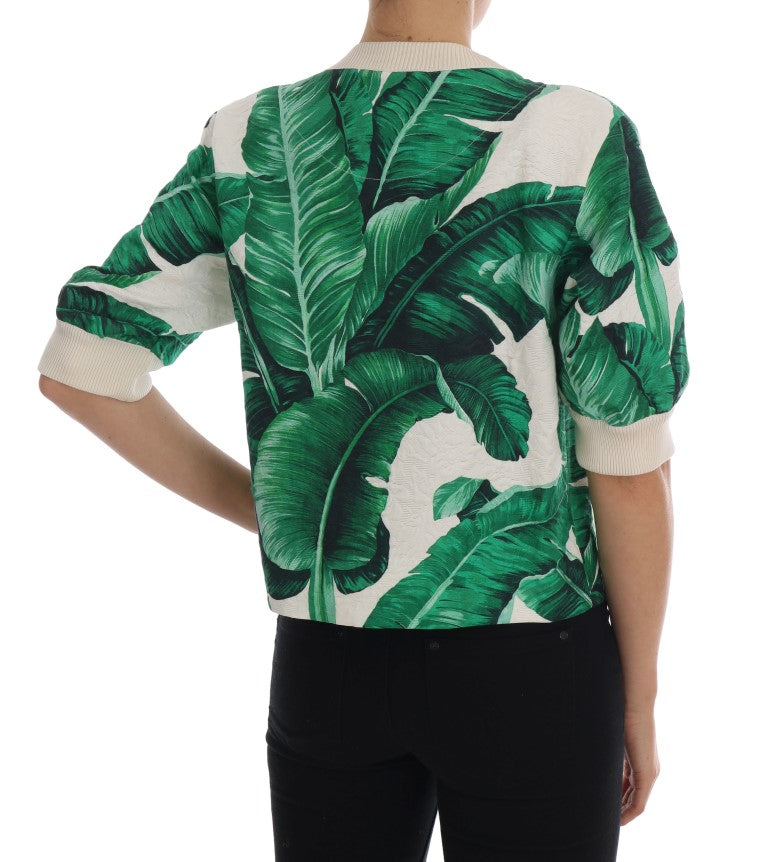 Green banana leaf print crewneck sweater with short sleeves and ribbed cream cuffs and neckline