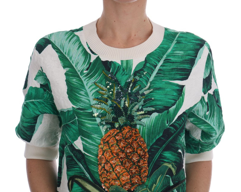 White and green banana leaf print knit crewneck sweater featuring a sequined orange pineapple motif