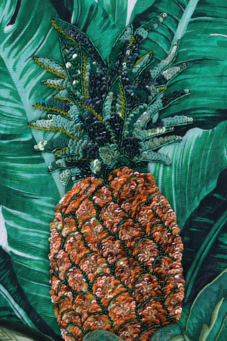 Orange and green sequin pineapple on a green tropical leaf print sweater