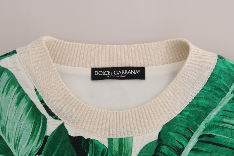 Close-up of a white knit crewneck sweater with a green banana leaf print and Dolce and Gabbana label