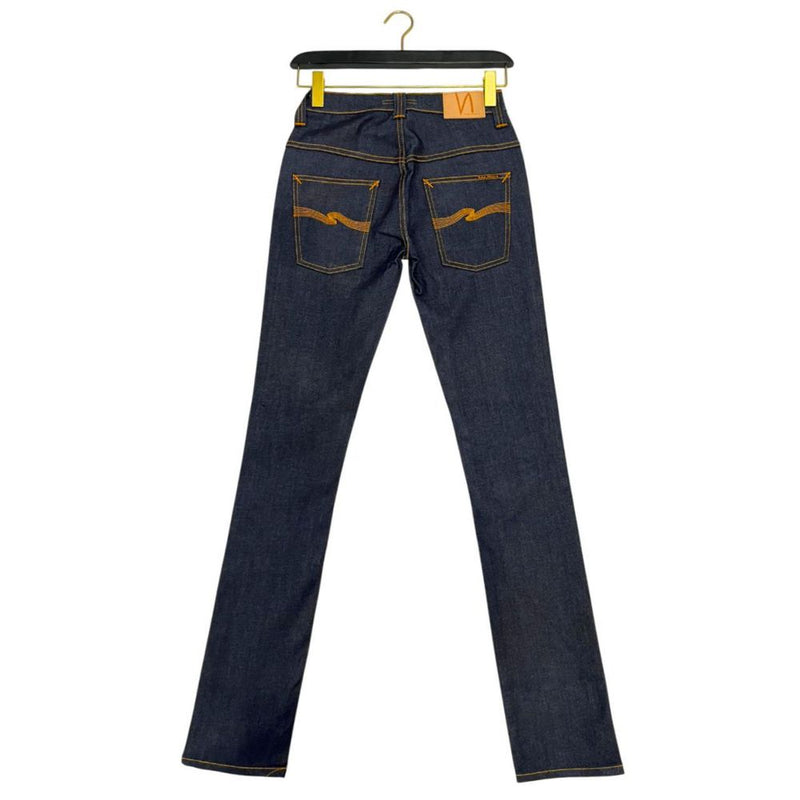 Dark blue denim women's jeans hanging by the waistband with orange stitching