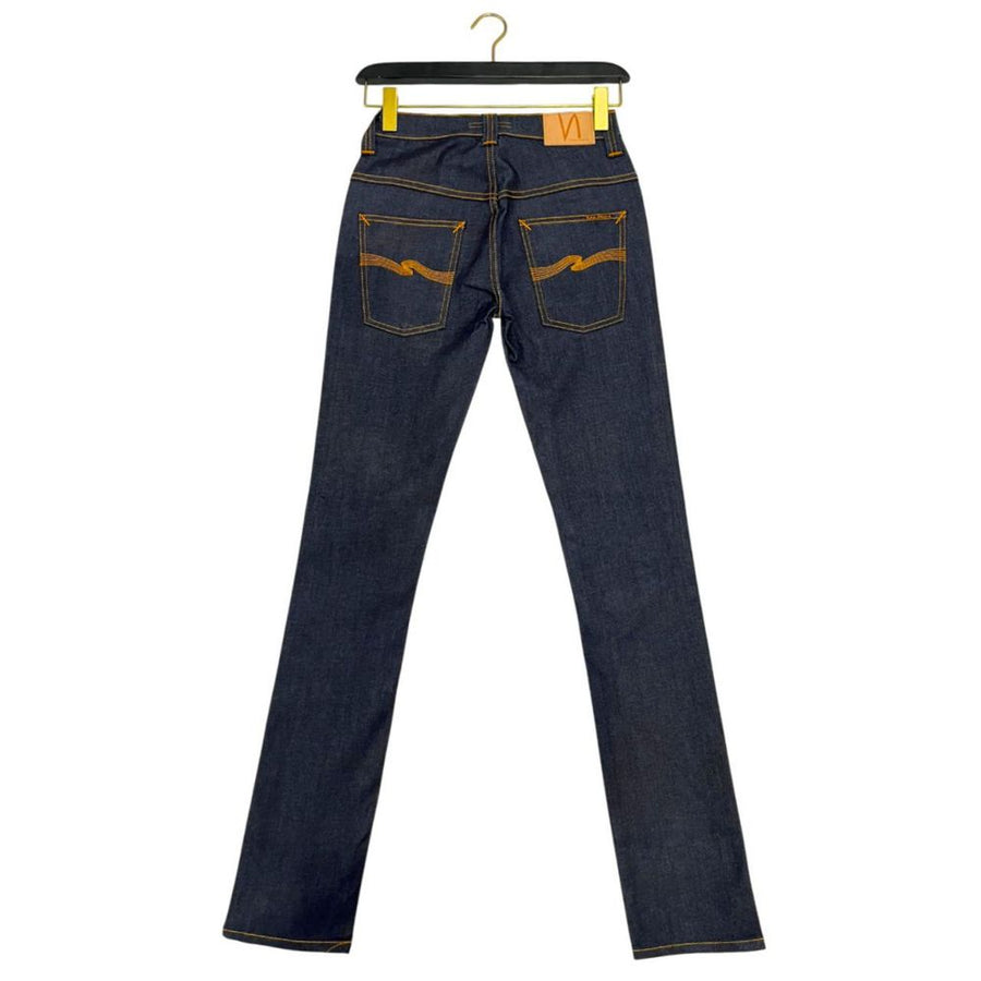 Dark blue cotton denim women's jeans with orange contrast stitching hanging on a black hanger
