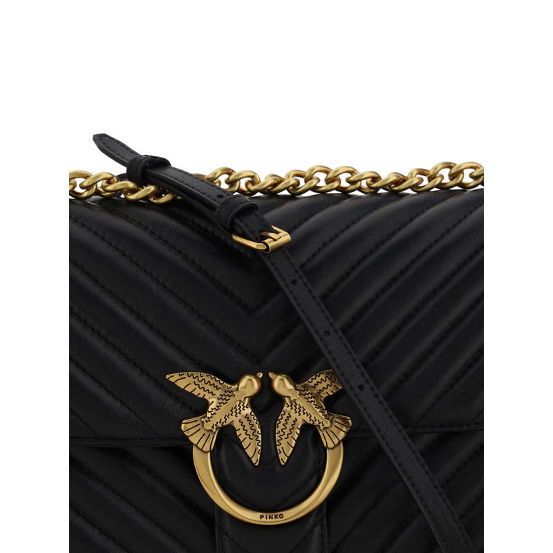 Black quilted leather shoulder bag with a chevron pattern, gold chain strap, and gold bird clasp closure