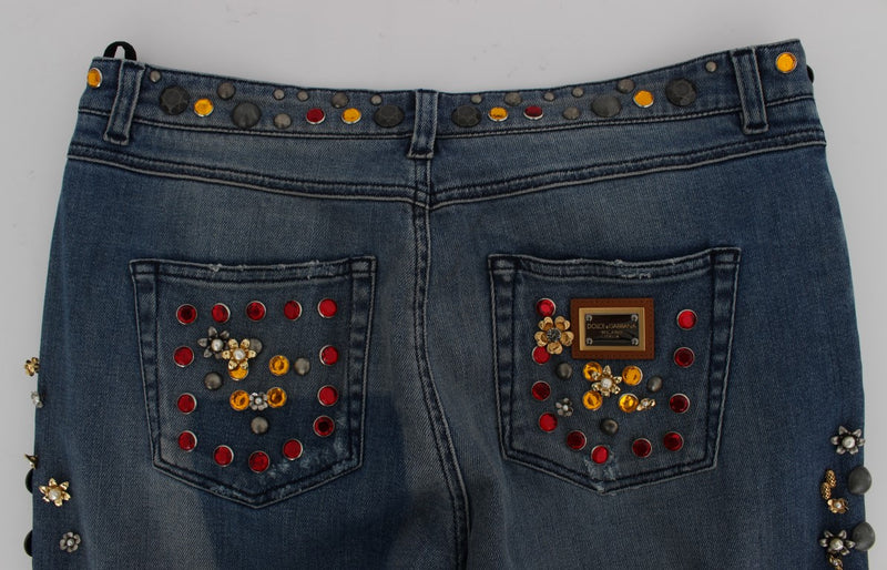 Blue denim jeans with crystal and stud embellishments on pockets and waistband