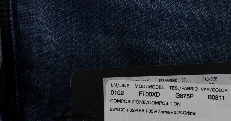 Dark blue denim material with a product tag attached displaying composition details