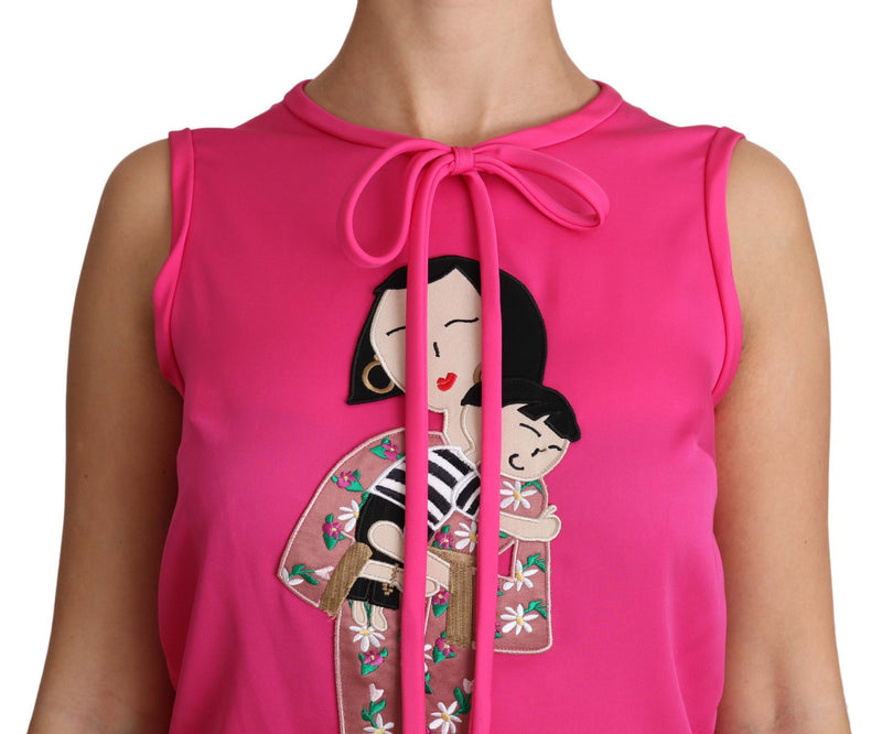 Bright pink sleeveless silk tank top with crew neck, neck tie, and embroidered mother and child graphic