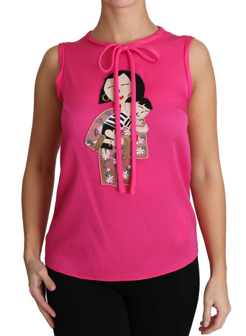 Bright pink sleeveless silk blouse with a tie-neck and embroidered mother and child applique