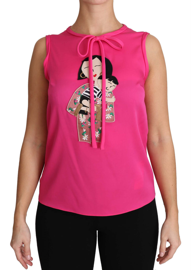 Bright pink silk sleeveless blouse with a bow tie neck and a mother and child graphic applique