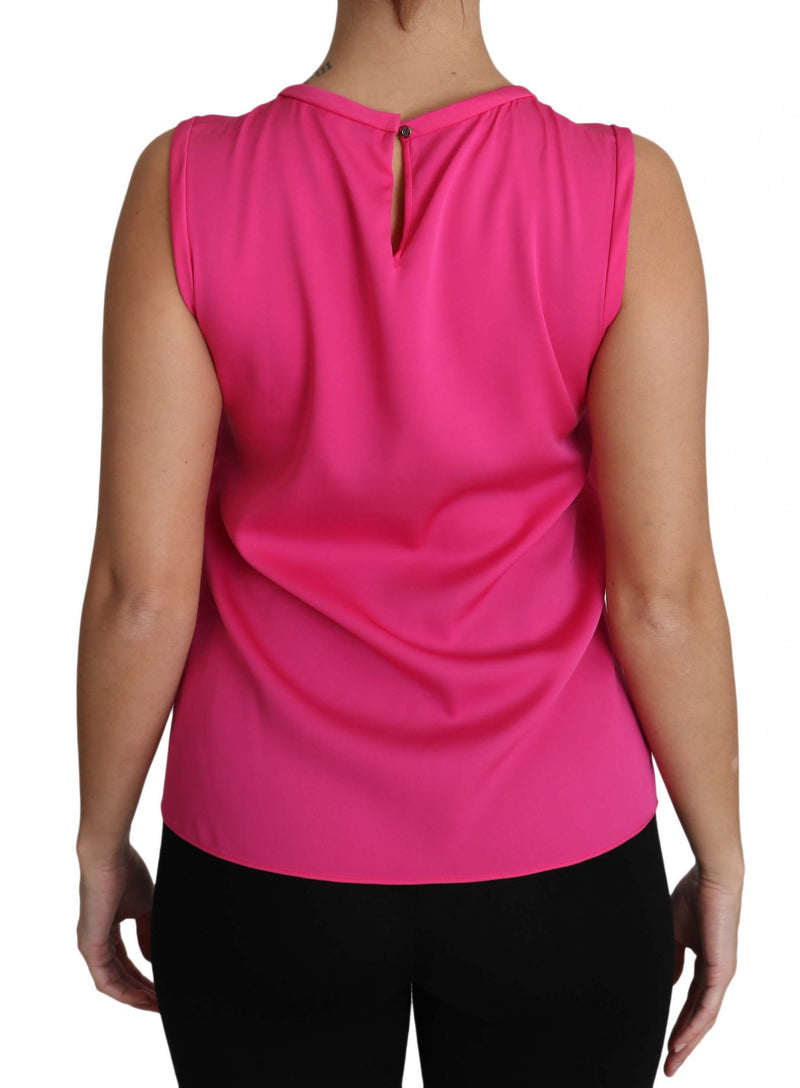 Pink sleeveless silk blouse with keyhole back button closure worn on a person