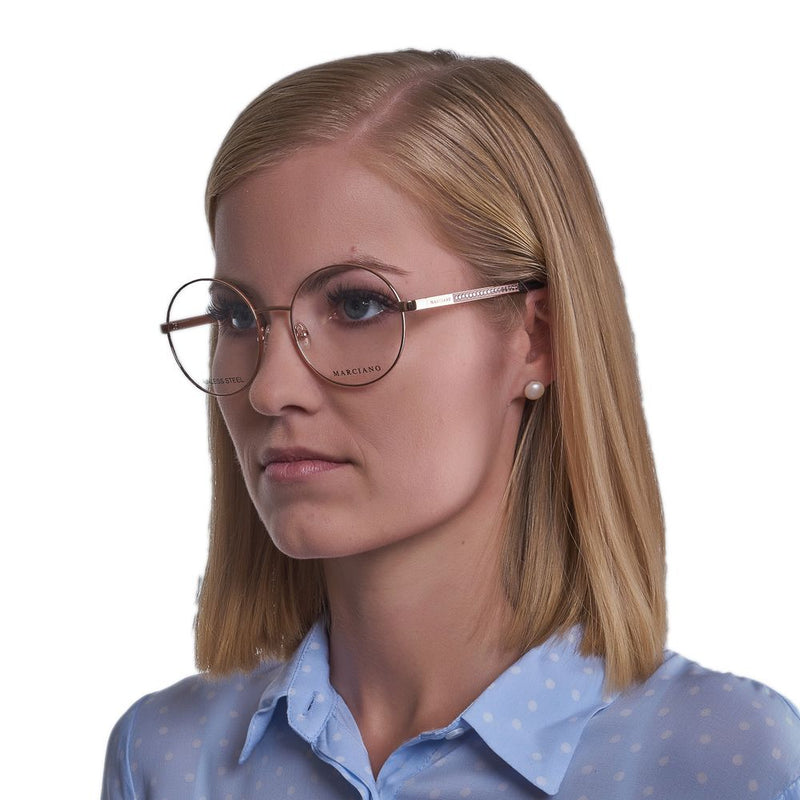 Round rose gold metal eyeglasses worn by a blonde woman in a light blue polka dot shirt