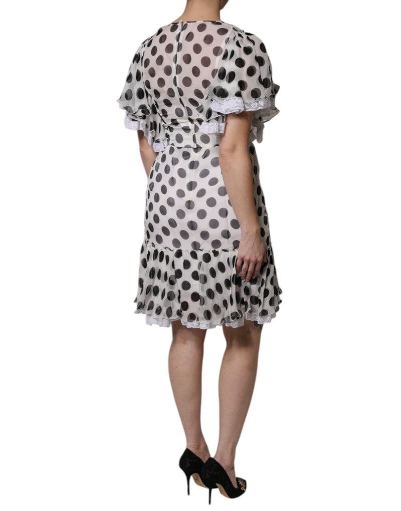 White silk blend a-line dress with black polka dots and ruffled hem