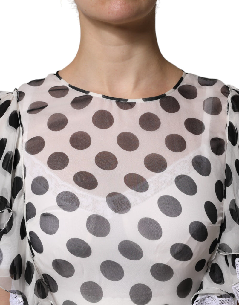 White silk blend a-line dress with black polka dots worn by a person