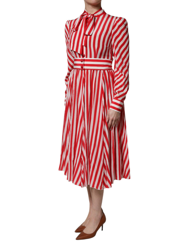 Red and white striped long sleeve midi dress with neck tie and pleated skirt