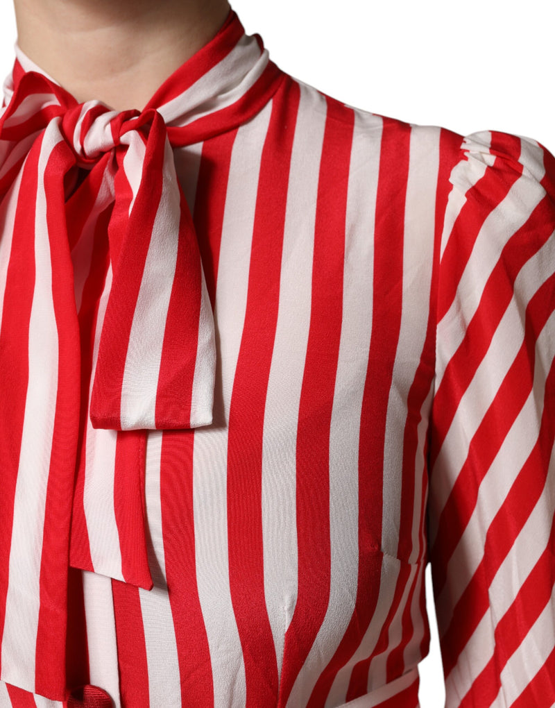 Silk midi dress with red and white vertical stripes, long sleeves, and a bow tie neckline