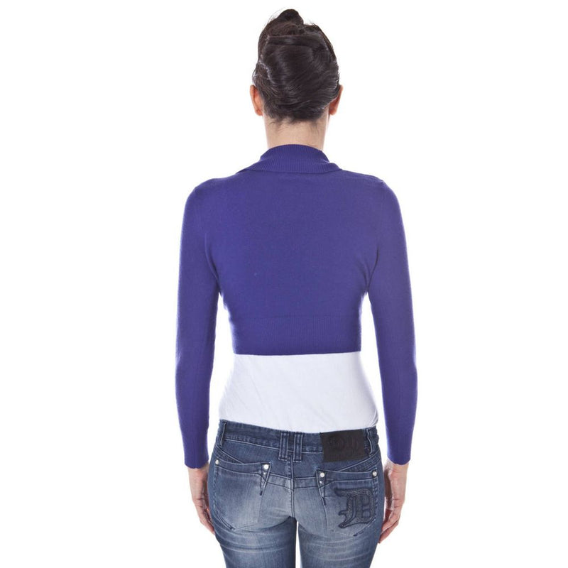 Royal blue knit shrug with long sleeves and high collar worn by a woman facing away