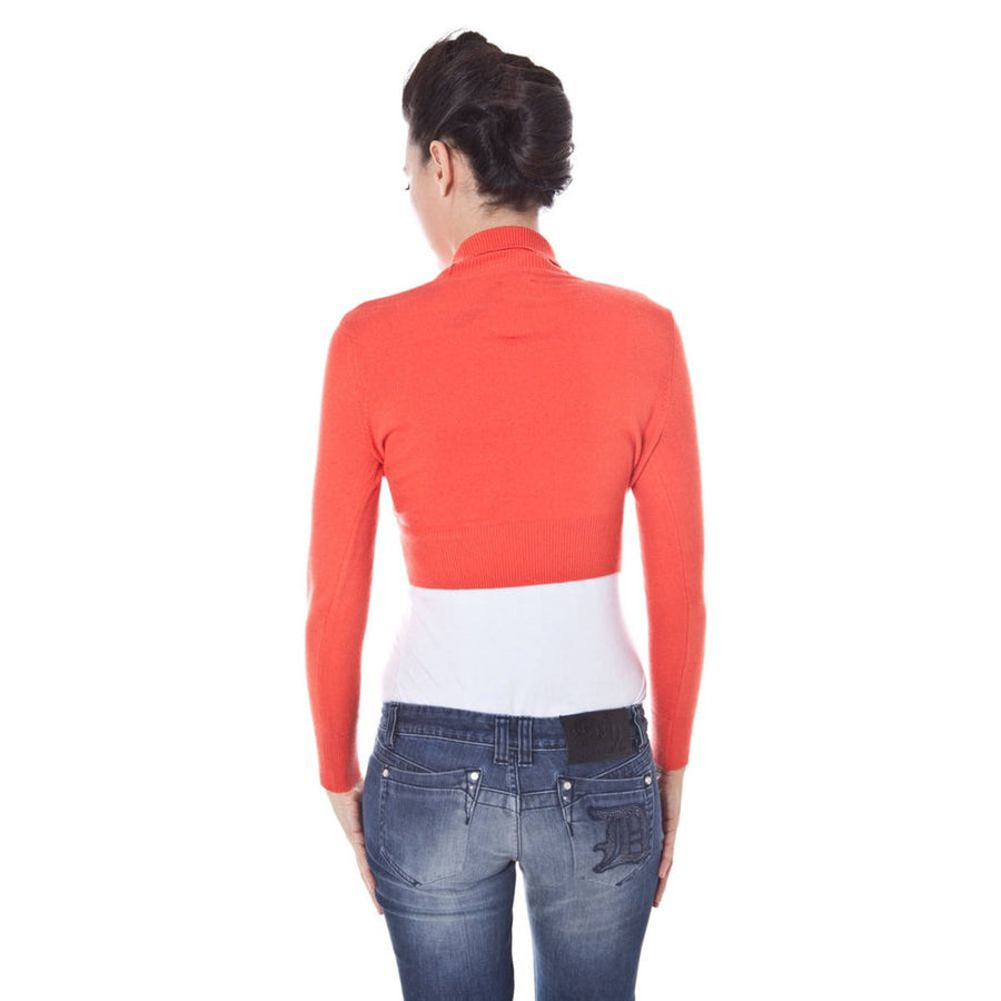 Red knit viscose cropped shrug with long sleeves and a shawl collar worn over a white top
