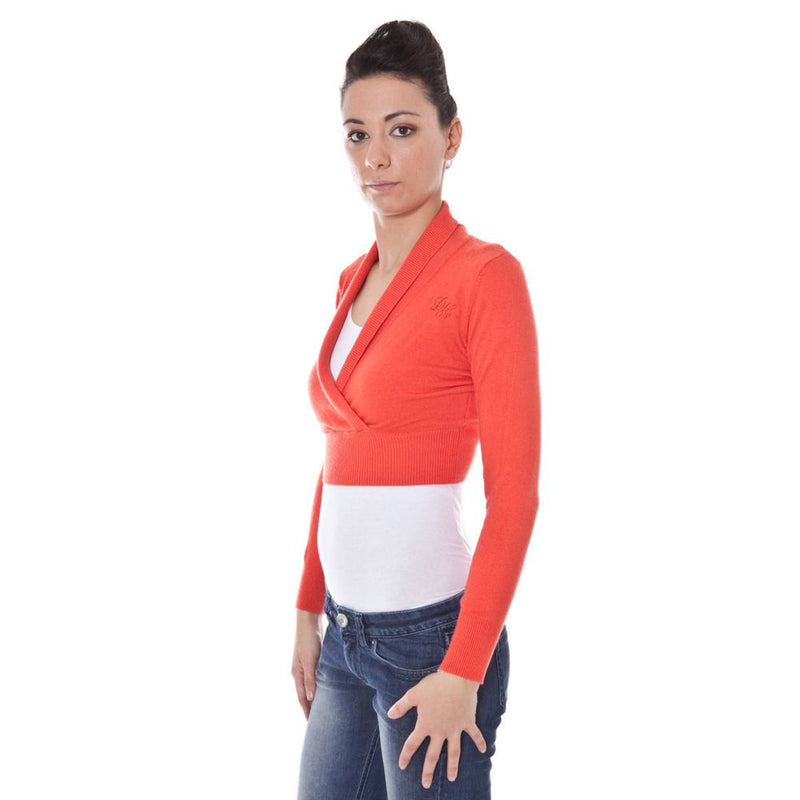 Red viscose knit cropped shrug worn over a white top and jeans