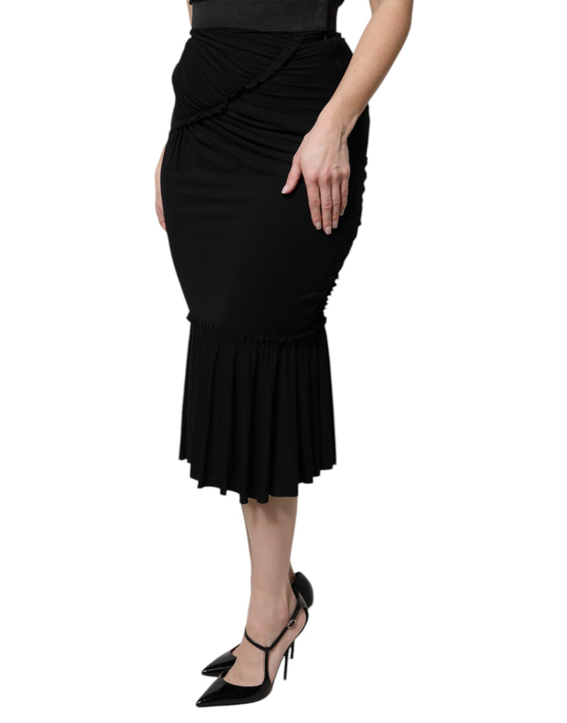 Black high-waist midi skirt with a mermaid cut, ruched hip detailing, and a ruffled hem