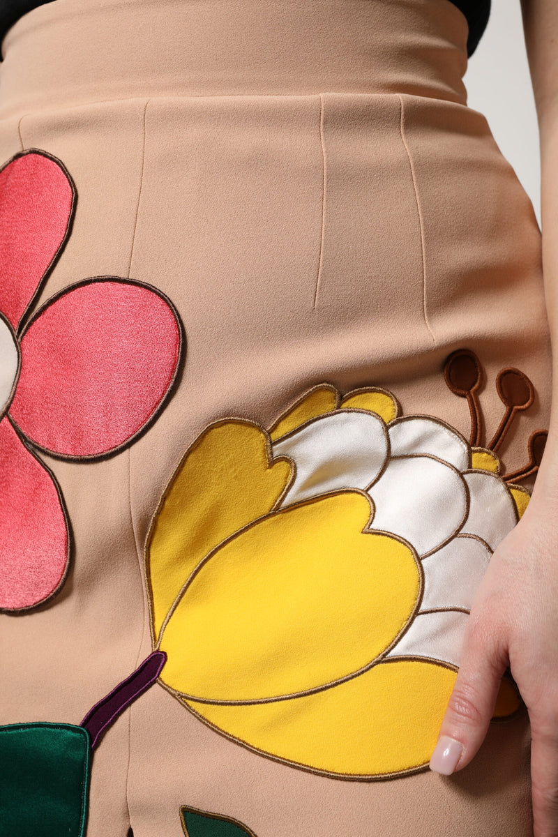 Beige high-waist pencil skirt featuring large colorful floral applique patches