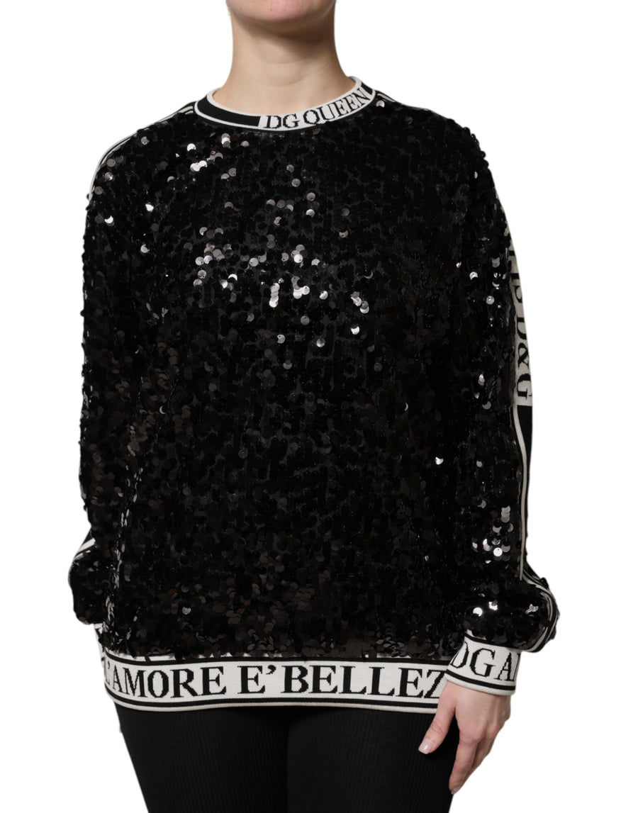 Black sequin pullover sweater with white banded text on collar, cuffs, and hem