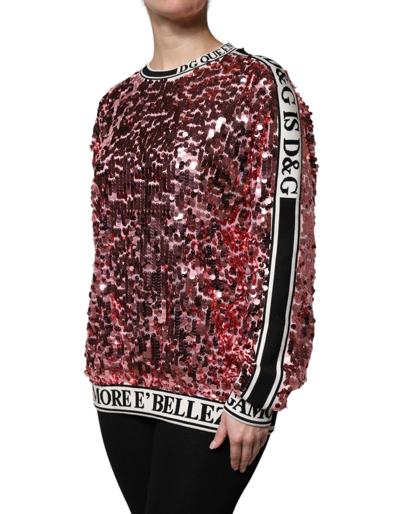 Pink sequin pullover sweater with black and white logo trim on the collar, hem, and sleeves