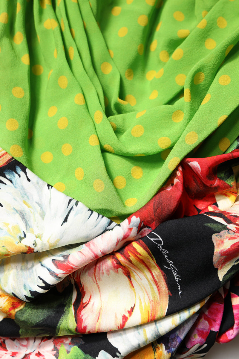 Close-up of a multicolor silk dress with green polka dot fabric and floral patchwork