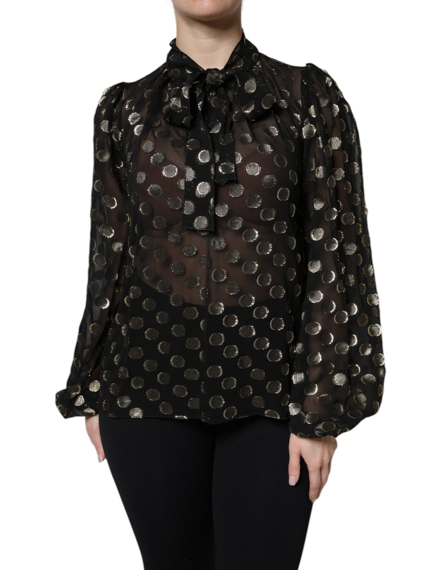Black sheer long-sleeve blouse with gold metallic polka dots and a tied neck bow