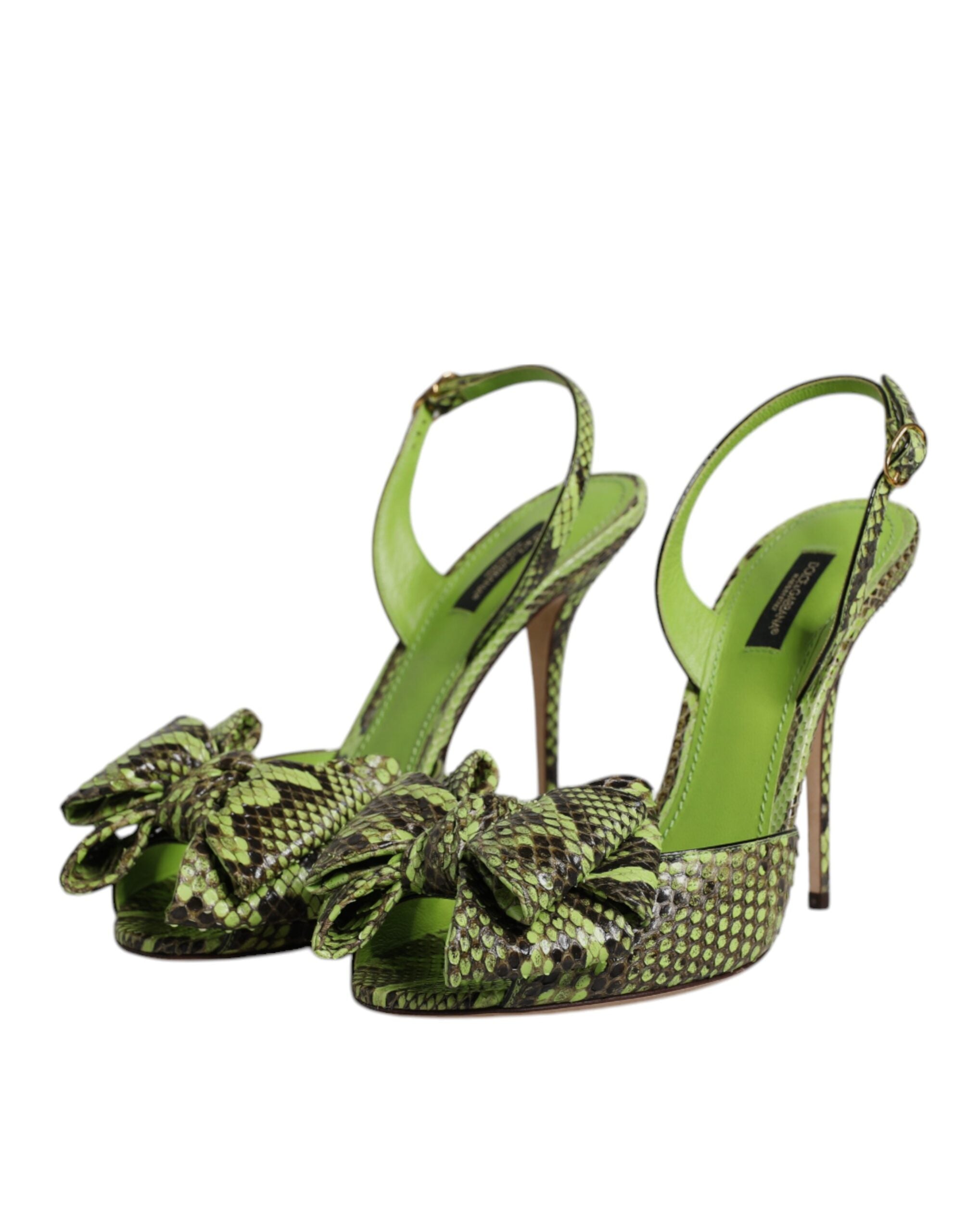 Dolce & Gabbana green python-print leather slingback heels with a prominent bow detail on the open toe.