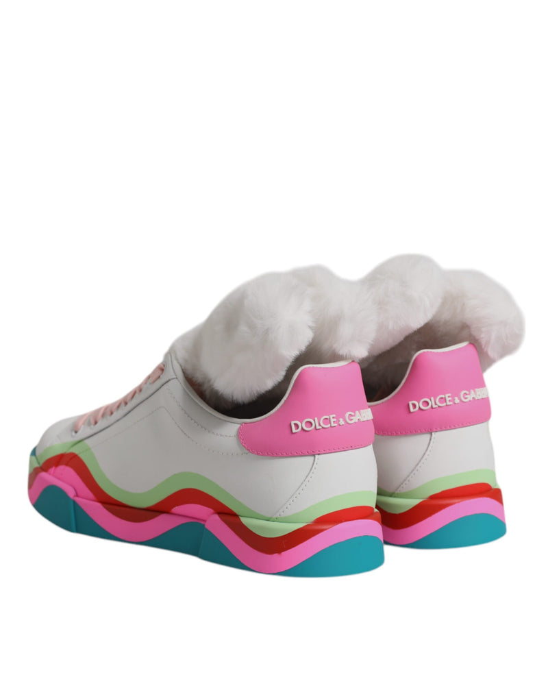 Dolce & Gabbana white leather low-top sneakers with faux-fur cuffs, pink heel tabs, and wavy multicolored soles.