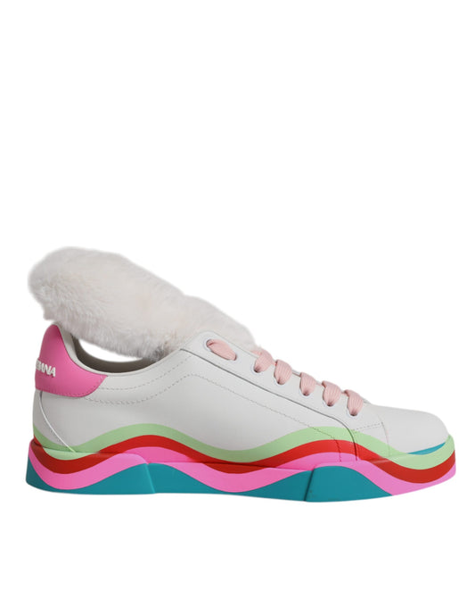Dolce & Gabbana white leather low-top sneakers with faux fur trim, pink laces, and wavy green, red, and blue soles.