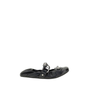 Black flat shoe with buckles on a white background