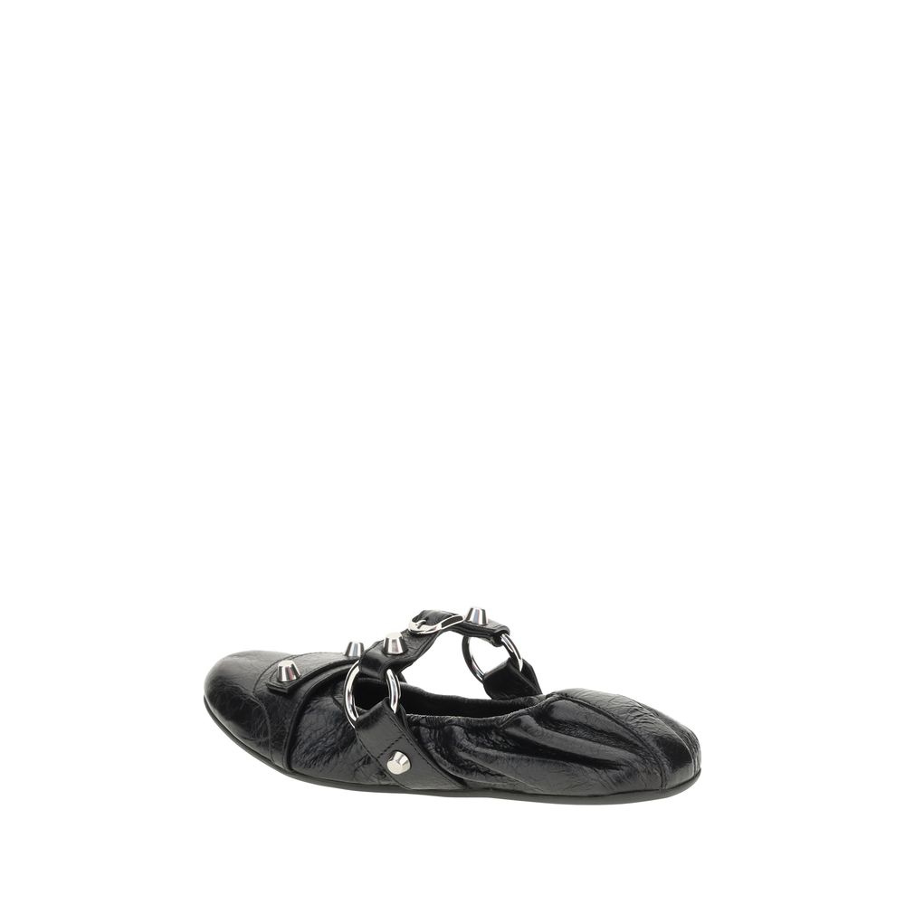 Black shoe with decorative straps on a white background