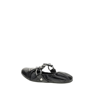 Black shoe with decorative straps on a white background