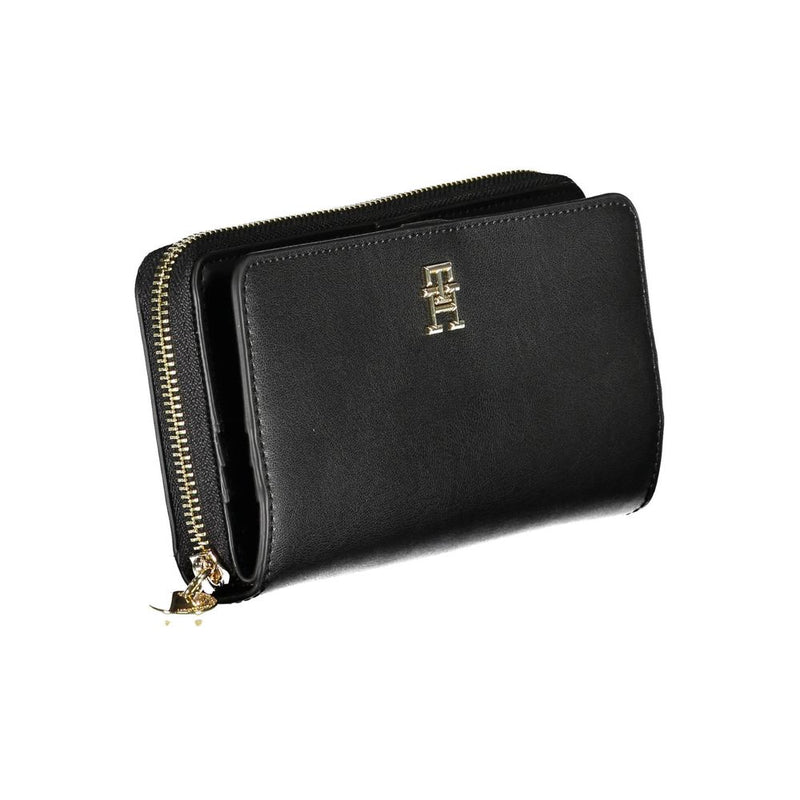 Black polyurethane women’s wallet with a gold zipper and metal monogram logo