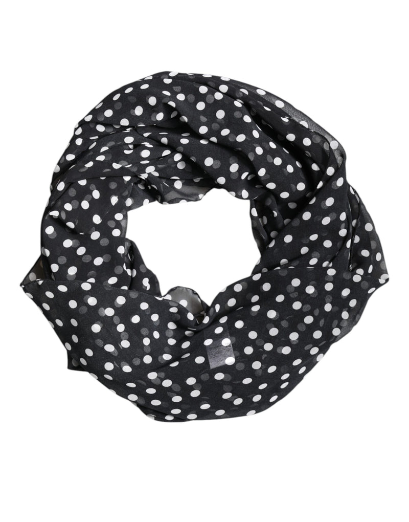Black sheer polyester wrap scarf with white polka dots coiled in a circle
