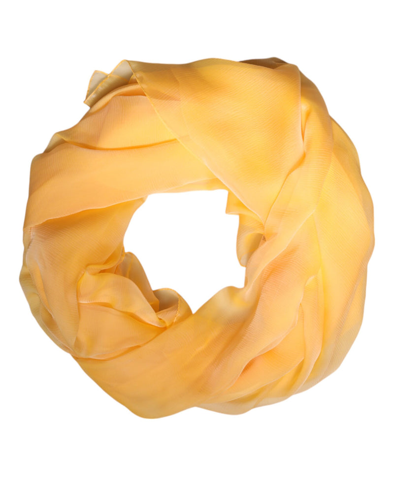 Bright yellow silk wrap scarf coiled in a circle against a white background